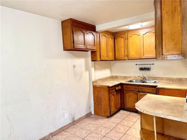 kitchen with sink and light tile patterned floors