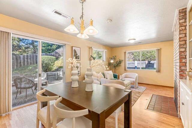 dining room with a notable chandelier and light hardwood / wood-style floors