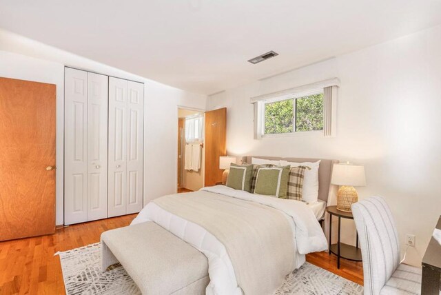 bedroom featuring light hardwood / wood-style floors and a closet