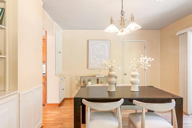 dining room featuring an inviting chandelier and light hardwood / wood-style flooring