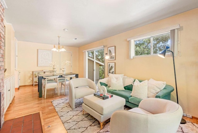 living room with a notable chandelier and light wood-type flooring