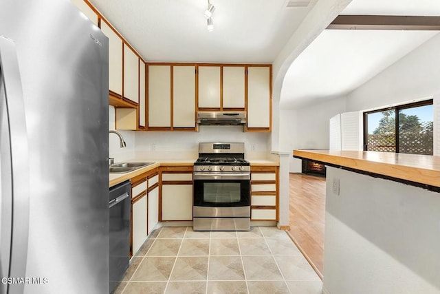 kitchen featuring sink, white cabinets, light tile patterned floors, and stainless steel appliances