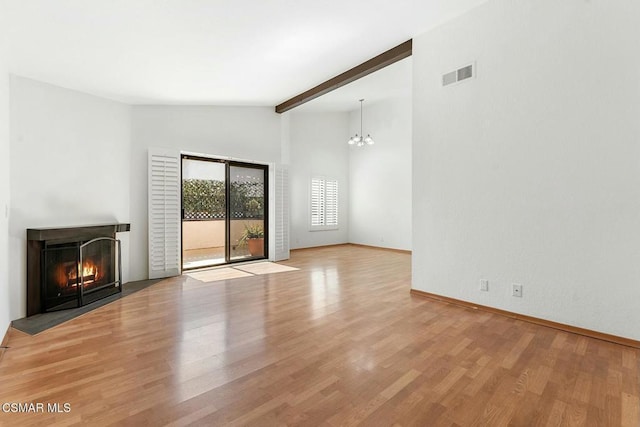 unfurnished living room with a chandelier, light hardwood / wood-style flooring, and lofted ceiling with beams