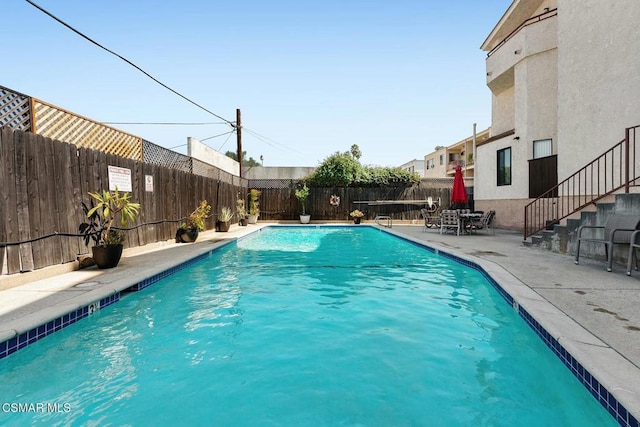 view of swimming pool featuring a patio area