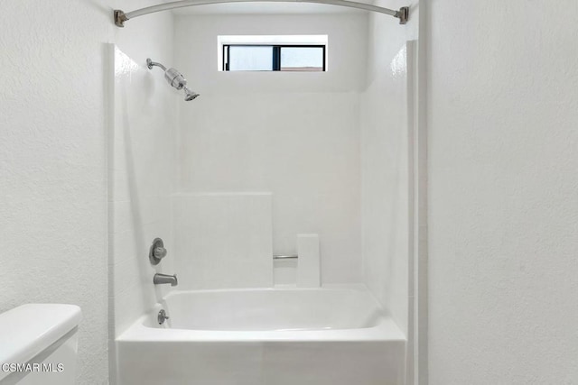 bathroom featuring toilet and tub / shower combination