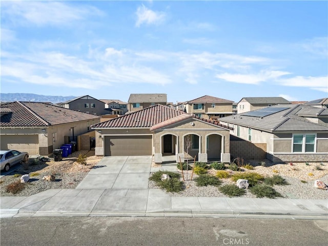 view of front of property featuring a garage and a mountain view