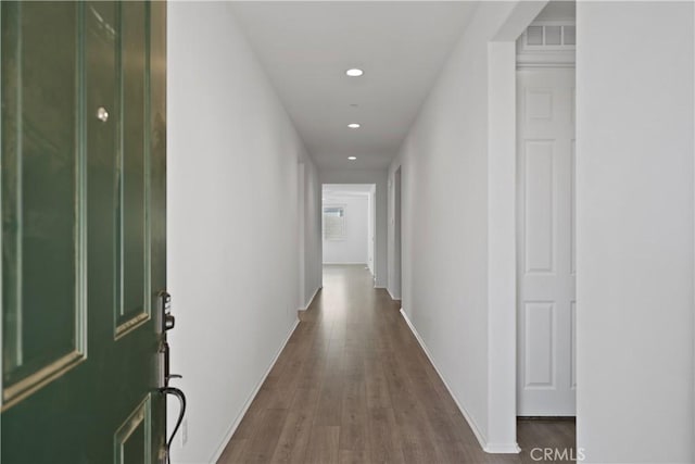 hallway with wood-type flooring