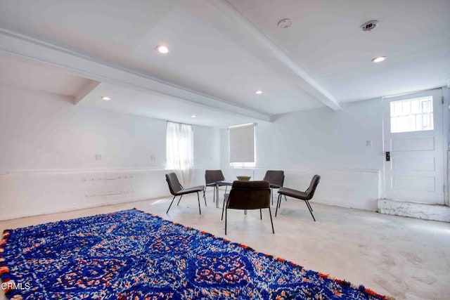 dining space with beamed ceiling