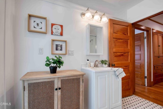 bathroom with ornamental molding and vanity