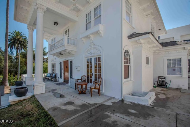 view of patio / terrace with french doors and a balcony