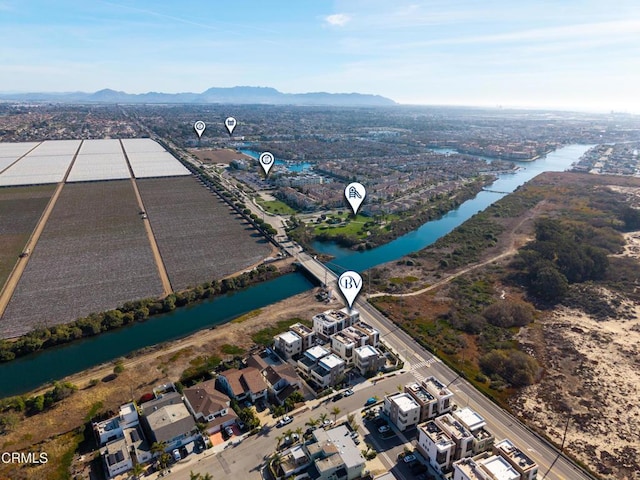 drone / aerial view featuring a water and mountain view