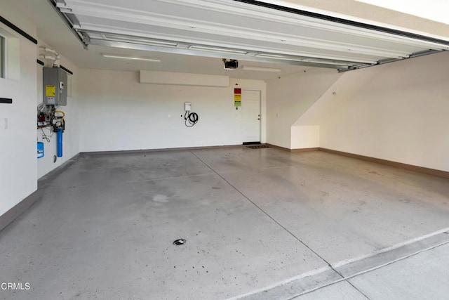 garage with water heater and a garage door opener