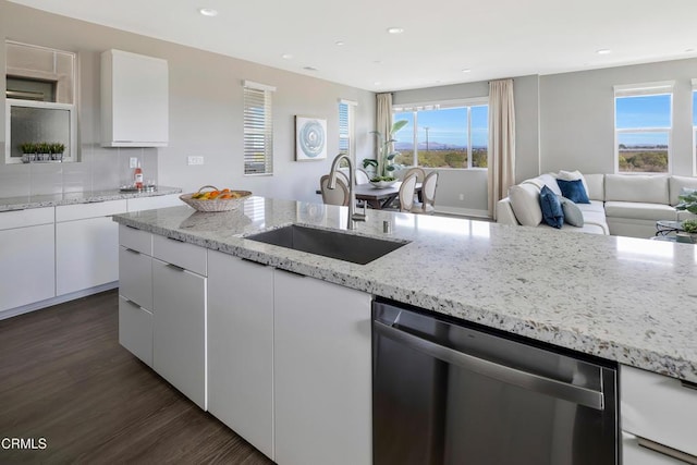 kitchen featuring dishwasher, sink, white cabinetry, and dark hardwood / wood-style floors