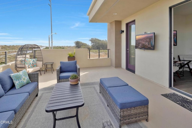 view of patio with an outdoor hangout area and a balcony