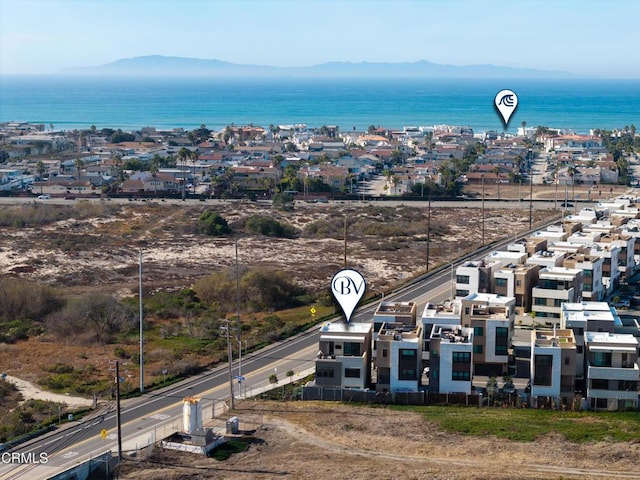 birds eye view of property featuring a water and mountain view