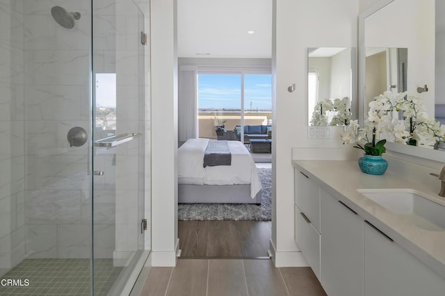 bathroom featuring an enclosed shower and vanity