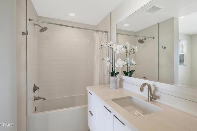 bathroom with shower / bathtub combination with curtain, visible vents, and vanity