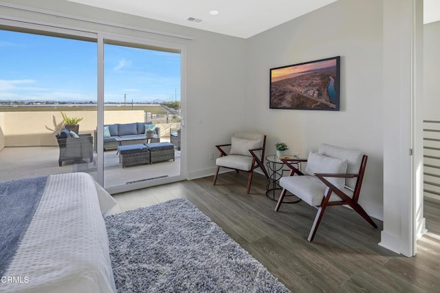 bedroom featuring recessed lighting, visible vents, wood finished floors, access to outside, and baseboards