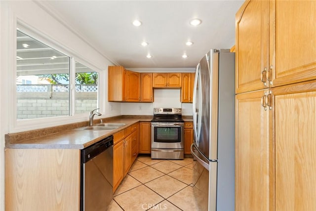 kitchen with sink, light tile patterned floors, ornamental molding, and stainless steel appliances