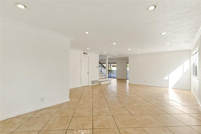 tiled empty room featuring ornamental molding