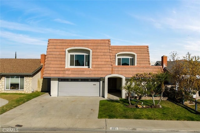 view of front of home with a garage and a front yard