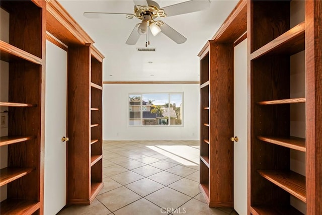 spacious closet with ceiling fan and light tile patterned floors