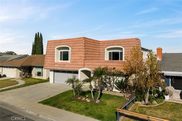 view of front of home with a garage and a front lawn