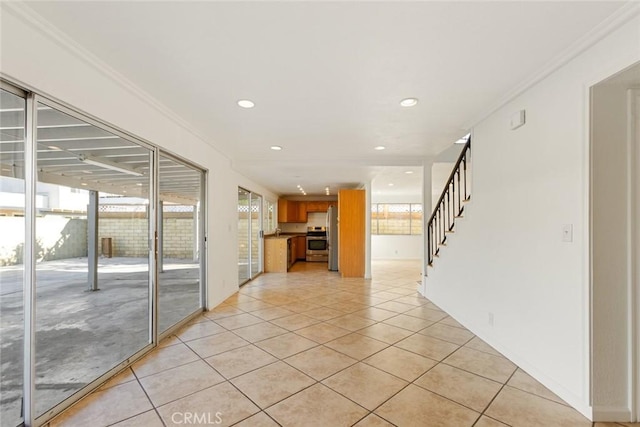 interior space featuring plenty of natural light, crown molding, and light tile patterned flooring