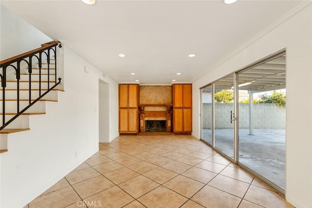 unfurnished living room featuring light tile patterned flooring and crown molding