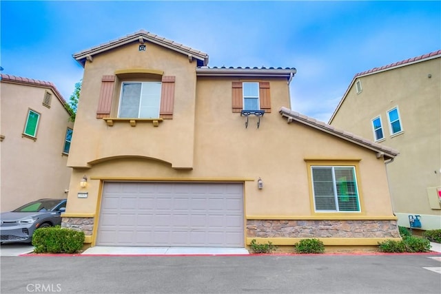 mediterranean / spanish-style home with a garage