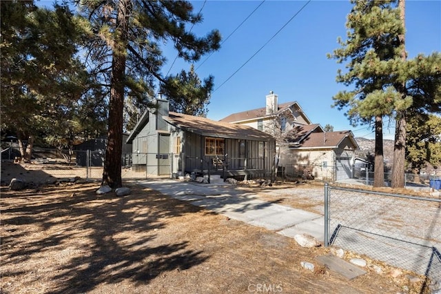 view of front of home with fence and a gate