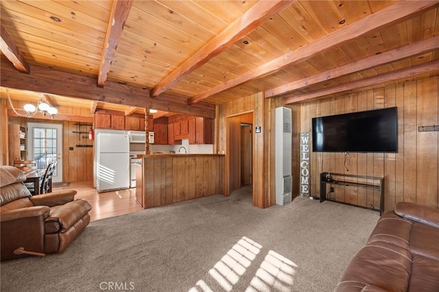 living area featuring wooden ceiling, wooden walls, a chandelier, and beam ceiling