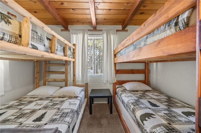 bedroom featuring carpet floors, beam ceiling, and wood ceiling