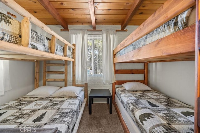 bedroom featuring carpet floors, beamed ceiling, and wood ceiling