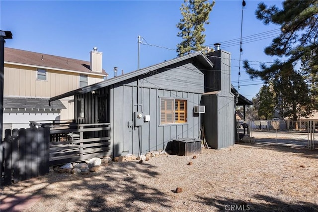 exterior space with a chimney and fence