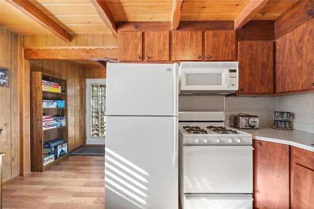 kitchen with light countertops, wooden ceiling, wooden walls, white appliances, and beamed ceiling