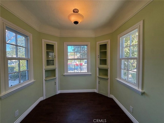 interior space with a textured ceiling and dark hardwood / wood-style floors