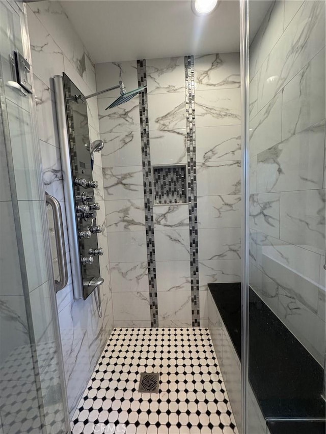 bathroom with a shower with door