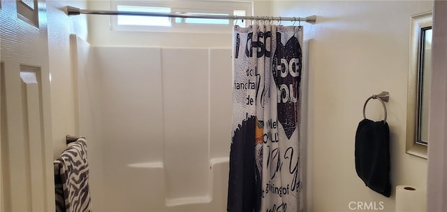 bathroom with a shower with shower curtain