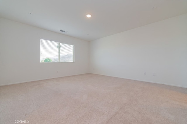 unfurnished room featuring light colored carpet