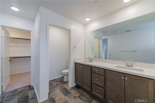 bathroom featuring toilet and vanity