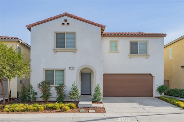 mediterranean / spanish-style home with a garage