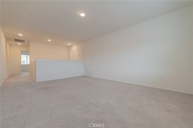 spare room featuring light colored carpet