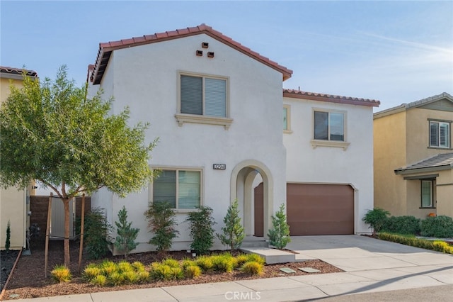 mediterranean / spanish-style house with a garage