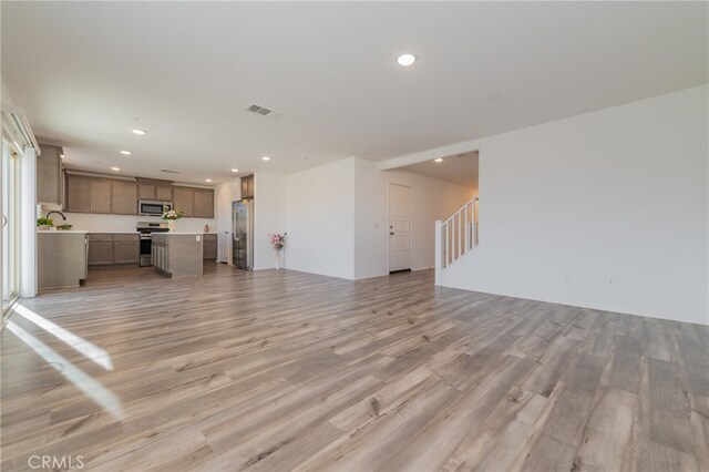 unfurnished living room with light hardwood / wood-style flooring