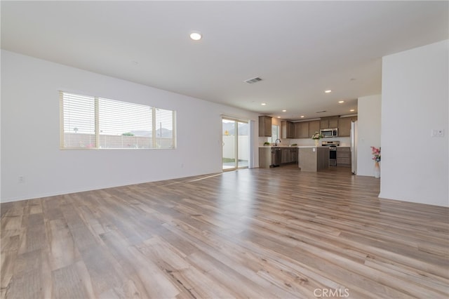 unfurnished living room with light hardwood / wood-style flooring