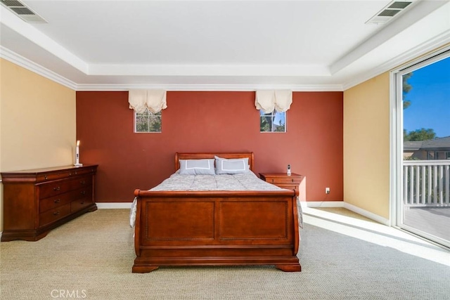 carpeted bedroom with access to outside, a notable chandelier, and a raised ceiling