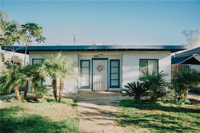 property entrance with a yard