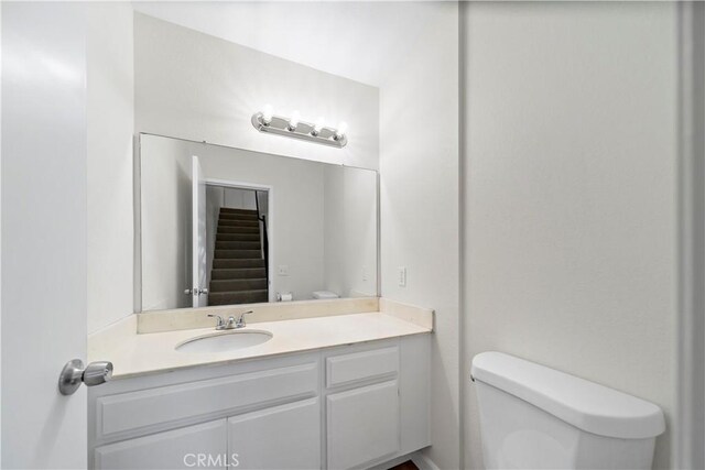 bathroom with toilet and vanity