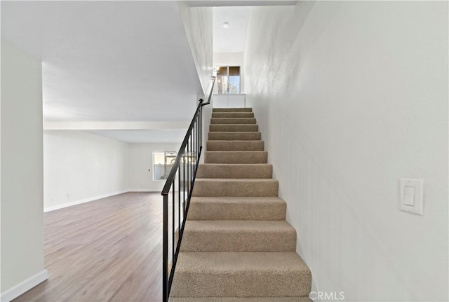 stairs featuring wood-type flooring